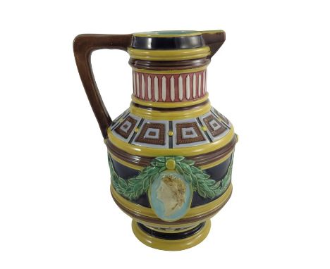 A Wedgwood majolica jug, circa 1870, cylindrical baluster form, relief moulded with classical portrait medallions and laurel 