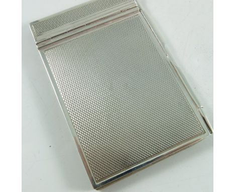 A George VI silver aide memoire, Walker and Hall, Chester 1938, engine turned with propelling pencil, 8cm long, 5cm wide