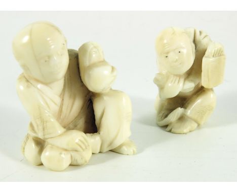 Two 19th century Japanese netsuke, Meiji, modelled as crouching figures, one holding a book (2)