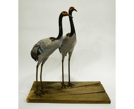 A Pair of Large Chinese Cloisonné Enamel Models of Cranes, circa 20th century, each with long gilt coloured legs and the plum