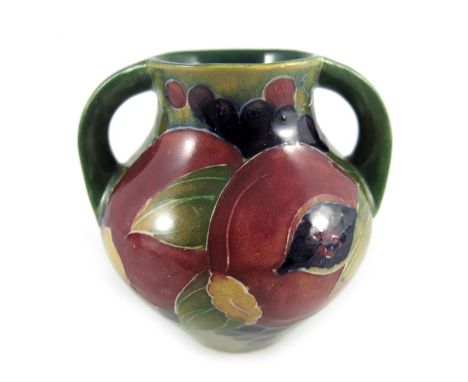 William Moorcroft, a small Pomegranate on ochre vase, circa 1914, twin handled amphora form, impressed Burslem marks and unde