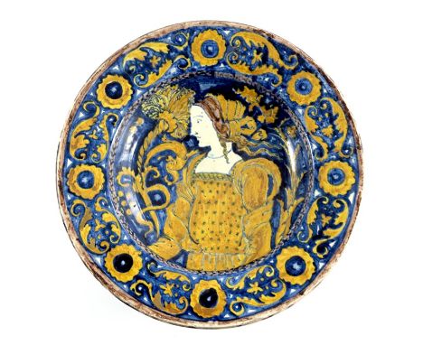 A Della Robbia art pottery dish, 1894, footed form, painted with a Renaissance woman within a foliate scroll and rosette bord