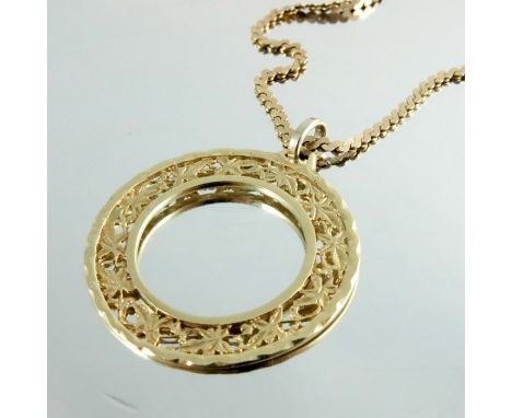 A Kutchinsky 9 carat gold pendant, London 1983, on Italian gold chain, ring form, reticulated and etched with scrolling vine 