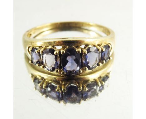 A Yellow Gold Ladies Dress Ring mounted with amethysts, modern, the five graduated stones on a raised arched mount, hallmarke