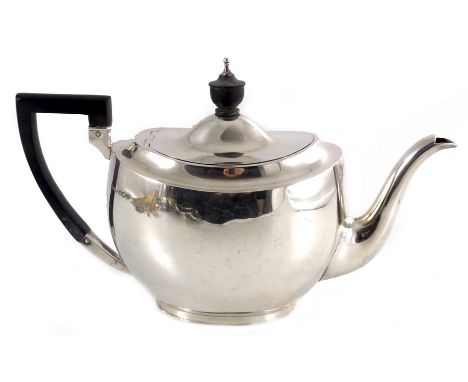 A George VI silver three piece tea set, E Silver and Co., Sheffield 1946, Neoclassical boat form with ebony handle and finial