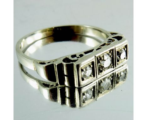 A 14 carat white gold and diamond ring, the central diamond surmounted by two smaller diamonds, mounted in square frames and 