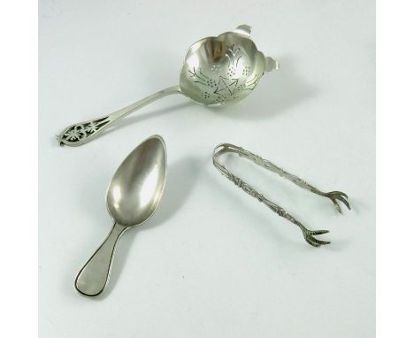 An Elizabeth II silver tea strainer, Edward Viner, Sheffield 1959, together with a Dutch silver caddy spoon and a pair of cas
