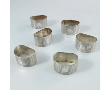 A set of six Art Deco silver napkin rings, George Randle, Birmingham 1928, kidney form with wavy engine turned stipes, vacant
