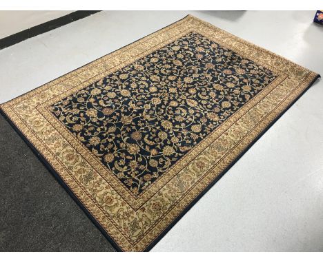 A Laura Ashley rug on blue ground together with one other fringed rug 