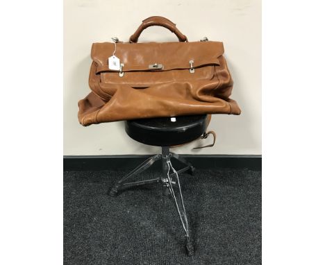 A brown leather velize together with a folding drummer's stool