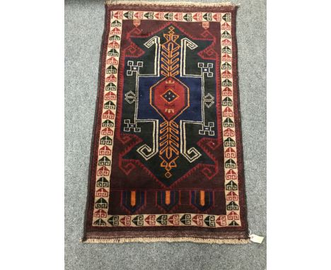 A Baluchi rug on red ground