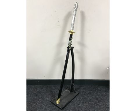 A Dragon handled samurai style sword on stand with scabbard  CONDITION REPORT: Overall length 90cm. Blade and tsuba somewhat 