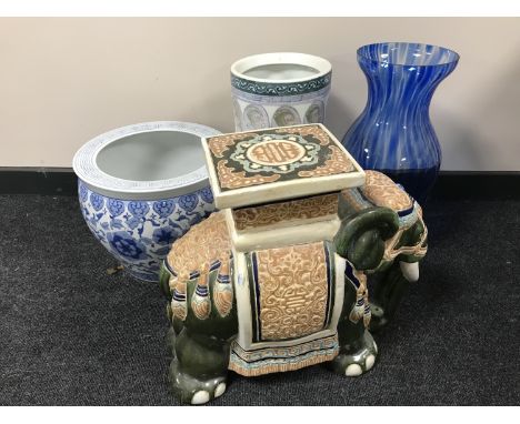 A pottery elephant plant stand together with a blue and white oriental style fish bowl, stick stand and vase 