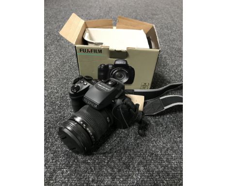 A Fujifilm Finepix HS 30 EXR camera, with strap, boxed. 