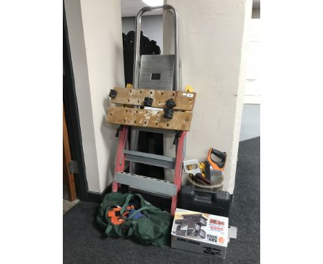 A set of folding aluminium steps together with a workmate hand and power tools 