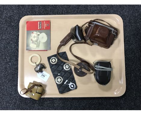 A Braun Paxette camera in case, miniature Minette camera, Weston Master V light gauge, speedway badges, child's elephant-form