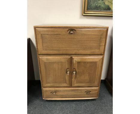 An Ercol elm cocktail cabinet