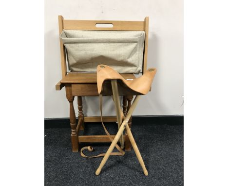 An oak lamp table fitted with a drawer together with a beech and Hessian magazine rack and folding tripod stool 