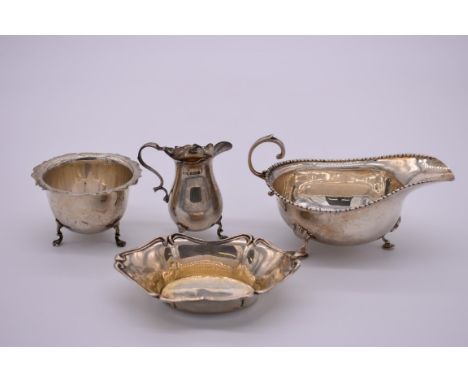 A silver sauce boat, by Horace Woodward &amp; Co Ltd&nbsp;, London 1916; together with a silver creamer and sugar basin, by S