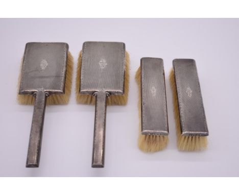 A silver engine turned four piece brush set, by&nbsp;Garrard &amp; Co Ltd, Birmingham 1954. 