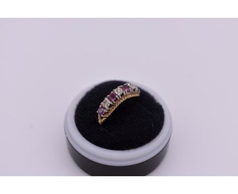 A ruby and diamond gold ring, hallmarked 375, 2g total weight. 