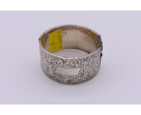 A Victorian chased silver cuff bangle,&nbsp;51g. 