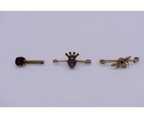 An opal, ruby and pearl yellow metal 'Bee' brooch, 3.5cm long; a garnet set 'Halley's Comet' example; and one another. (3) 