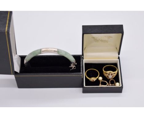 A pair of gold pearl screw earrings, stamped 14k; together with a jade bangle; and two fashion rings. (4) 