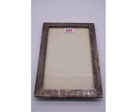 A silver engine turned photograph frame, by&nbsp;Charles S Green &amp; Co Ltd, Birmingham 1918, aperture 25 x 14cm. 