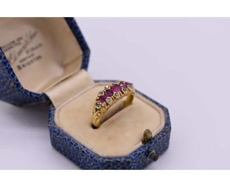 A ruby and diamond gypsy set gold ring, stamped 18, 5.2g total weight, (one stone missing). 