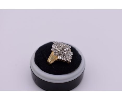 A baguette and brilliant cut diamond cluster gold ring, hallmarked 14ct, 1ct approximately, 6.1g total weight. 