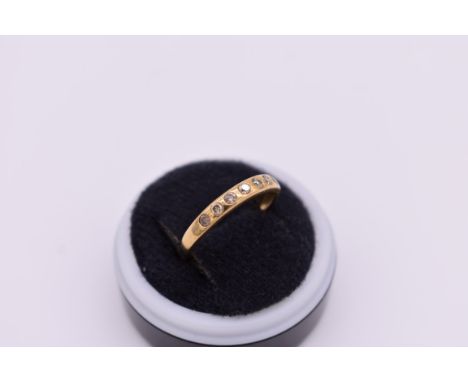 A diamond seven stone half eternity gold ring,&nbsp;hallmarked 9ct, 1.8g total weight. 