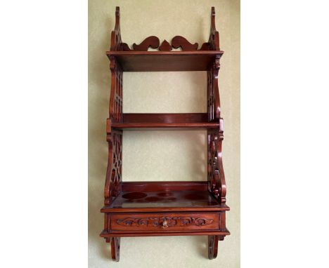 A decorative wall shelf with drawer to base and fretted sides. 84 h x 34 w x 19cm d. 