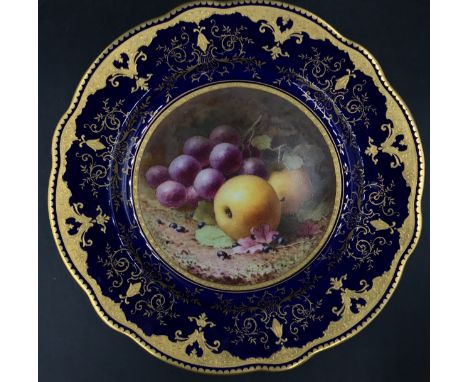 A Coalport scalloped cabinet plate by Frederick H. Chivers. Having cobalt blue and raised gilt border and painted with fruit.