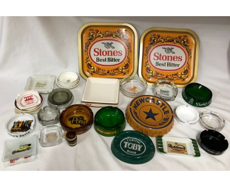 Brewery memorabilia to include ceramic and glass ashtrays and two metal trays together with various other ashtrays. 