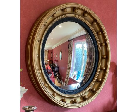 A large gilt convex wall mirror. 66cm d. 