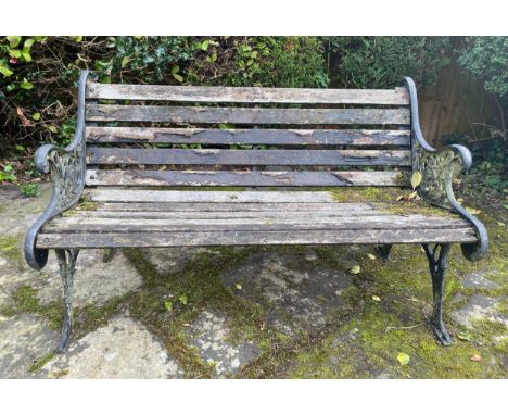 A wooden and cast iron bench. 126 w x 78cm h. 