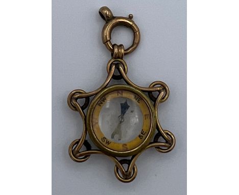 A nine carat gold cased compass 2.5cm d. Weight 6.4gm. 