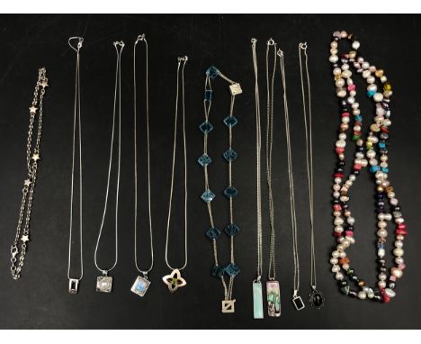 A collection of 11 necklaces to include a string of multi-coloured pearls, 2 silver enamel chains, 2 jet and silver chains, a