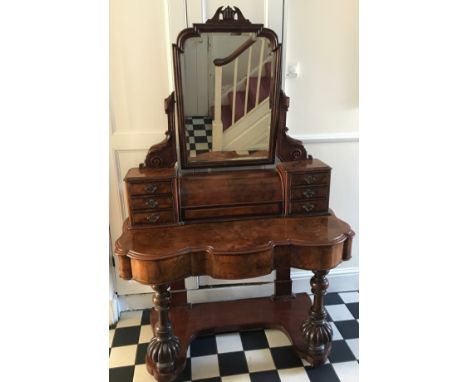 A Victorian figured walnut dressing table with frieze drawers, swivel mirror, seven drawers to top and on wheel feet. 180 h x