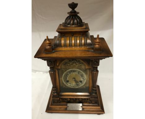 A bracket clock with a label H.A.C. 14 Day Strike Made in Wurttemberg, with a plaque on the front "Presented to Miss F Ramsde