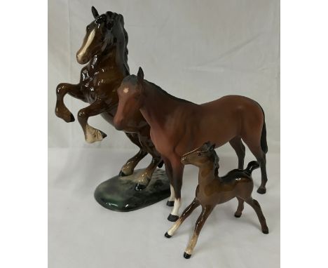 Collection of three horses one rearing horse by Beswick, a foal by Beswick and a Royal Doulton horse. 