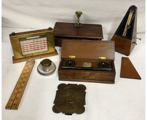 A selection of desk items to include metronome, three perpetual calendars, wooden box with two inkwells and pen and nib, a se