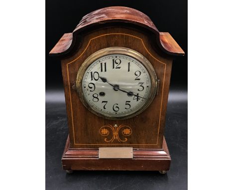 An inlaid mantle clock, the movement marked 16 and 1576 with engraved plaque to front 'Presented to Mr Leslie Lancaster....' 