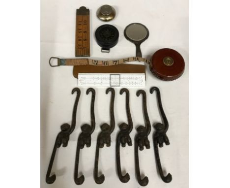 A collection of miscellaneous items to include a Sterling silver hand mirror, 6x metal monkeys with hanging arms, a WWII Germ