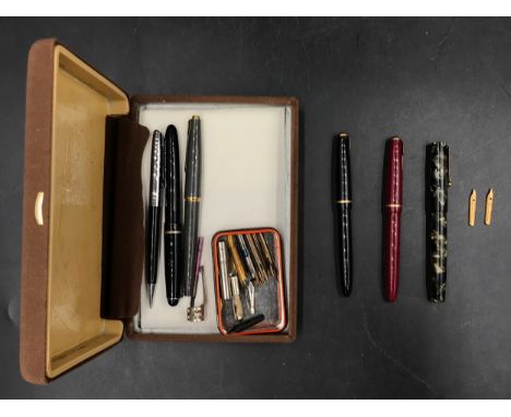 Three fountain pens with 14 carat nibs to include a Mabie Todd &amp; Co blackbird self filling pen and 2 x Parker together wi