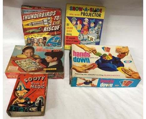 A collection of vintage boxed games to include Merit remote control driving test, thunderbirds to the rescue, hands down, sho