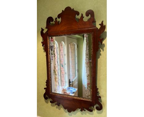 A small mahogany fretted wall mirror. 59.5 h x 36.5cm w. 