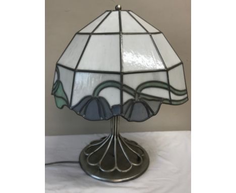 A heavy metal table lamp with a Tiffany style shade and an industrial style base. 57cm h x approx. 29cm base d. (10.6kg). 