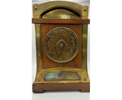 An Arts and Crafts oak and brass mantle clock. Probably Liberty. 37h x 25 w.